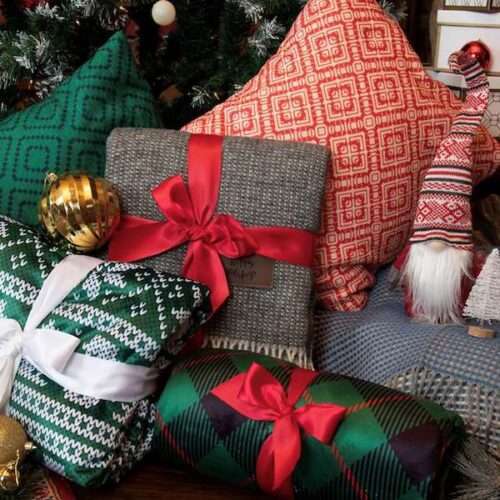 Christmas gifts wrapped in cozy winter blankets.