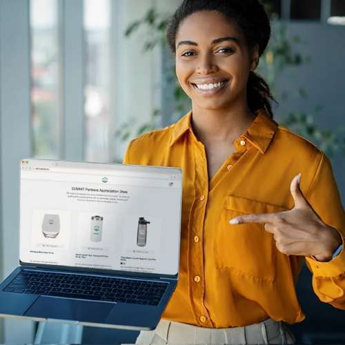 Woman with laptop open to products page.