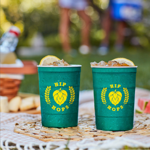 Two hip hops cups with iced drinks outdoors