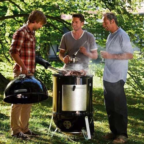 Friends barbecuing outdoors in a park.