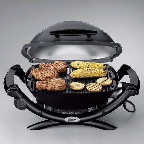 Portable grill with food cooking.